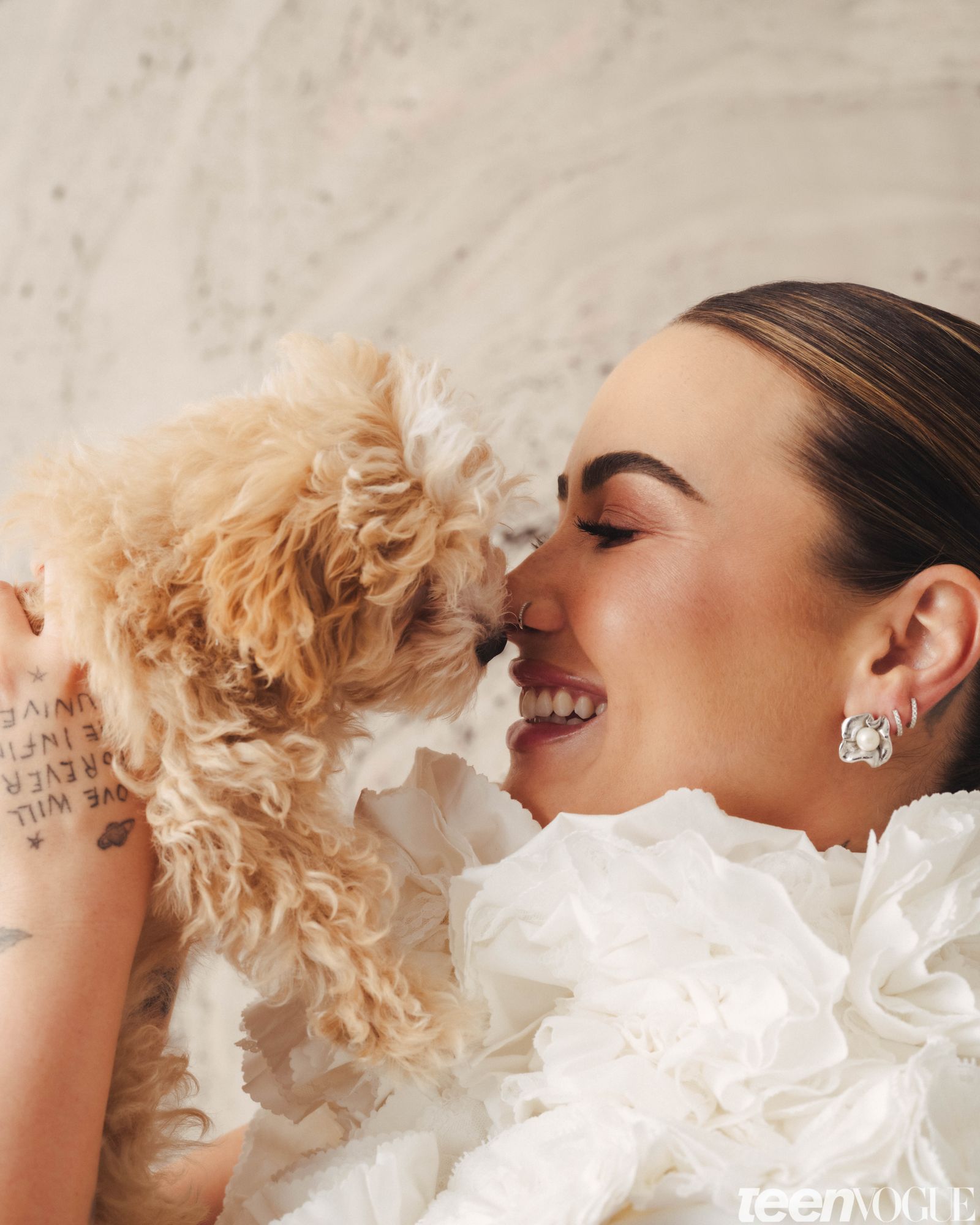 A closeup candid of Demi lovingly and happily holding her Puppy in her arms and them looking at each other.
