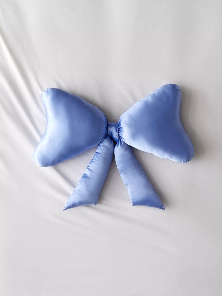 Image may contain: Cushion, Home Decor, Pillow, Accessories, Formal Wear, and Tie