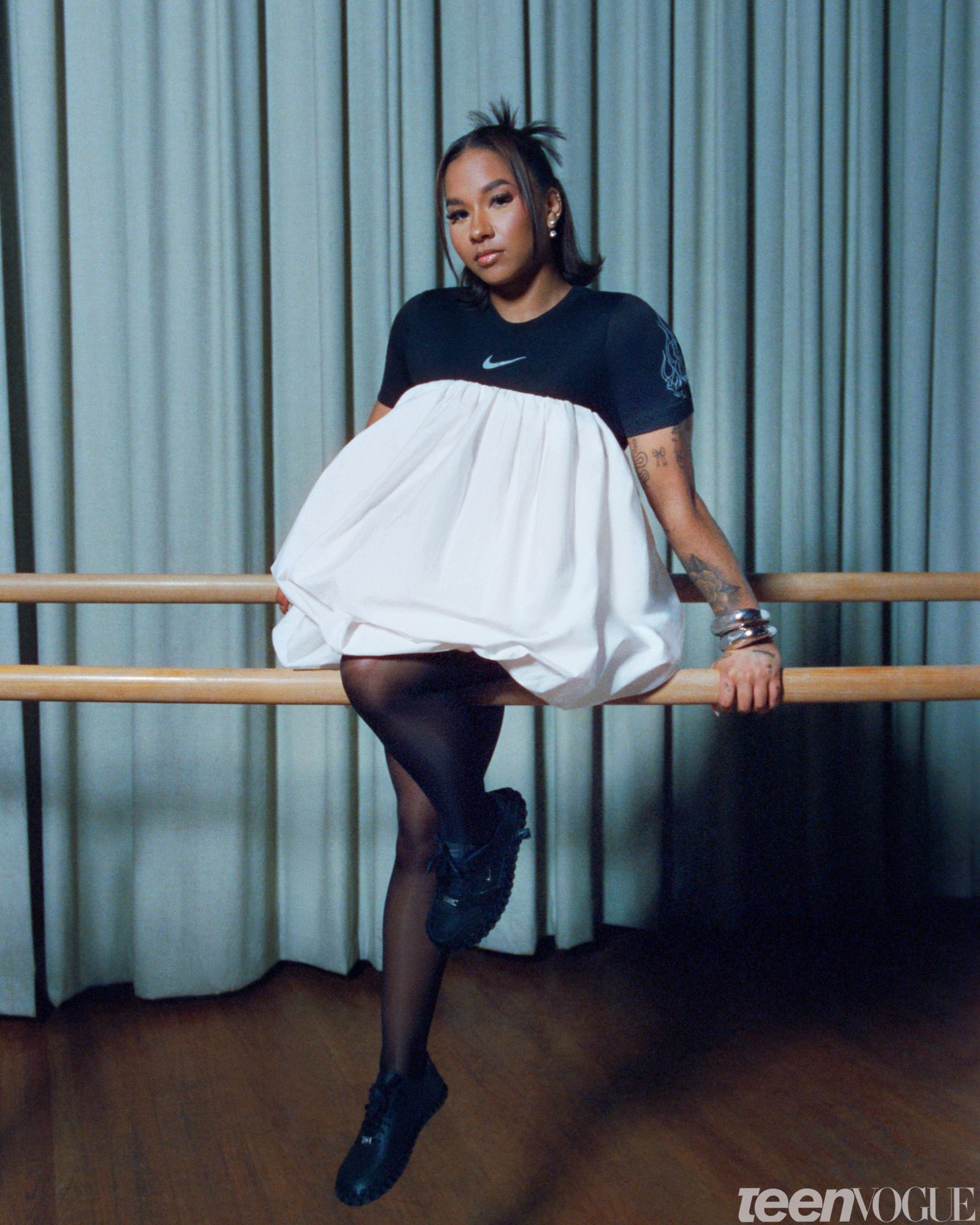 Portrait of the gymnast and Olympic Medalist Jordan Chiles sitting on a barre.