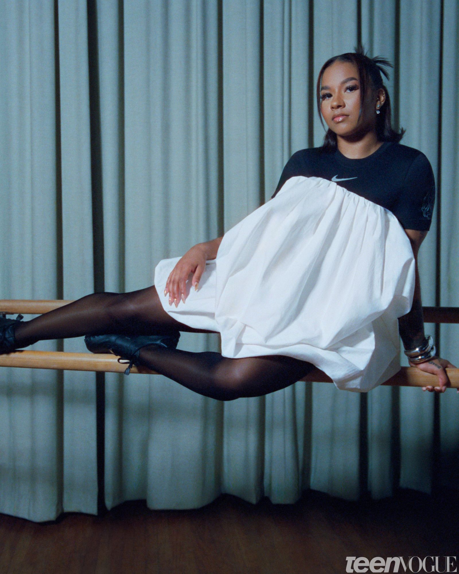 Portrait of the gymnast and Olympic Medalist Jordan Chiles sitting on a barre.