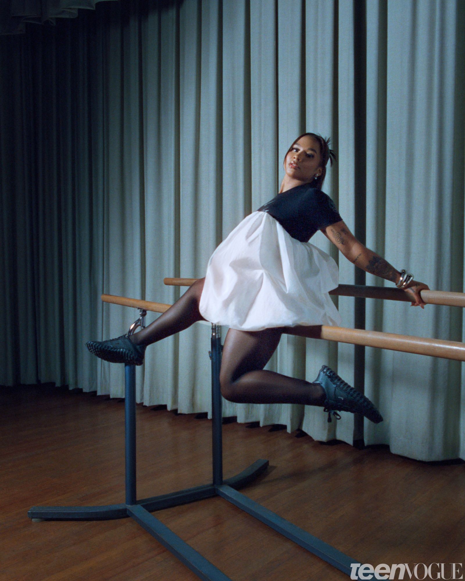 Portrait of the gymnast and Olympic Medalist Jordan Chiles sitting on a barre.