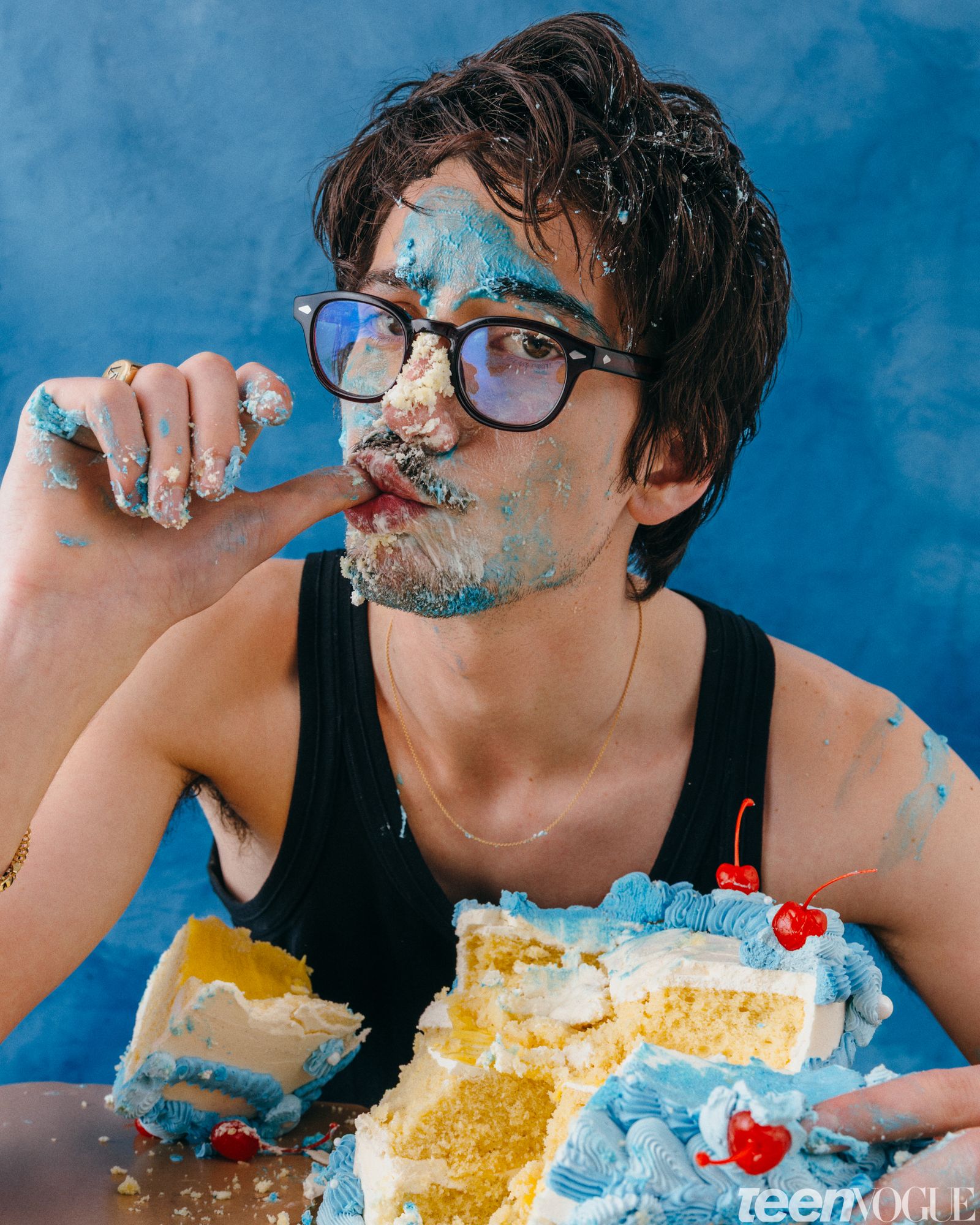 Milo with blue icing and leftovers from a birthday cake all over his face.