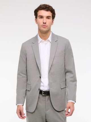 Image may contain Blazer Clothing Coat Jacket Formal Wear Suit Adult and Person