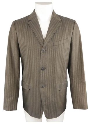Image may contain Blazer Clothing Coat Jacket Formal Wear and Suit