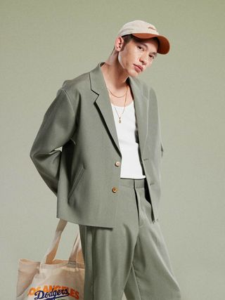 Image may contain Carlos I. Norega Clothing Formal Wear Suit Blazer Coat Jacket Accessories Bag and Handbag