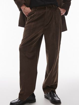 Image may contain Clothing Pants Adult Person Accessories Bracelet Jewelry and Coat