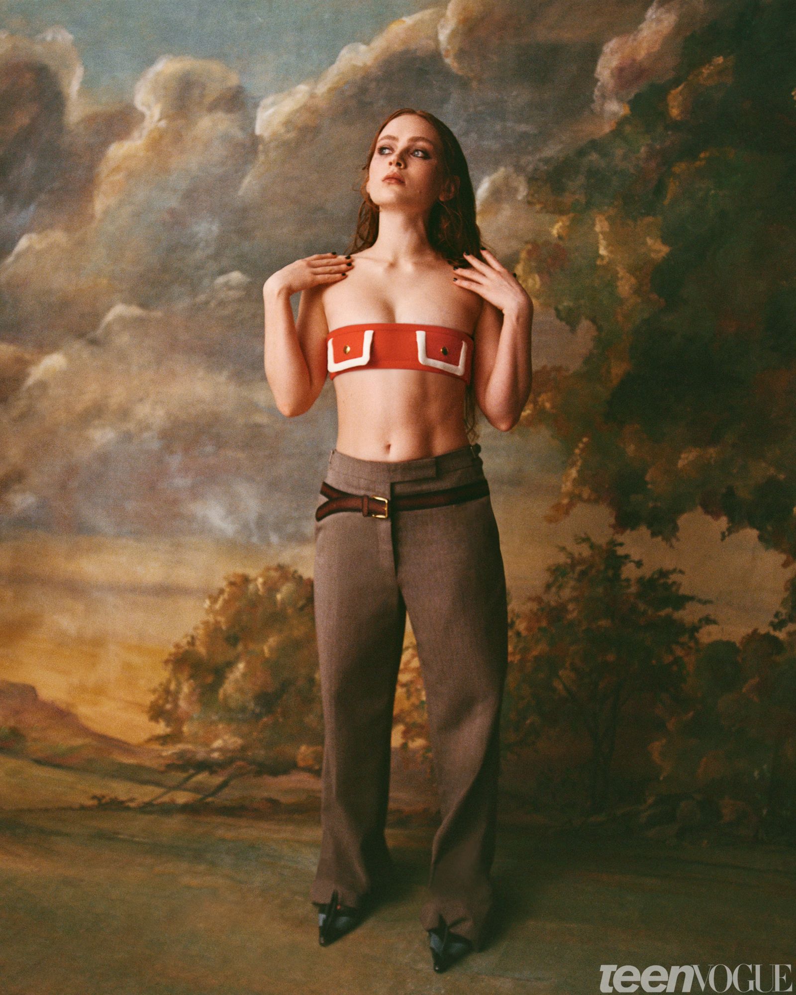 Sadie photographed wearing a Prada bandeau top against a painted backdrop of the sky.