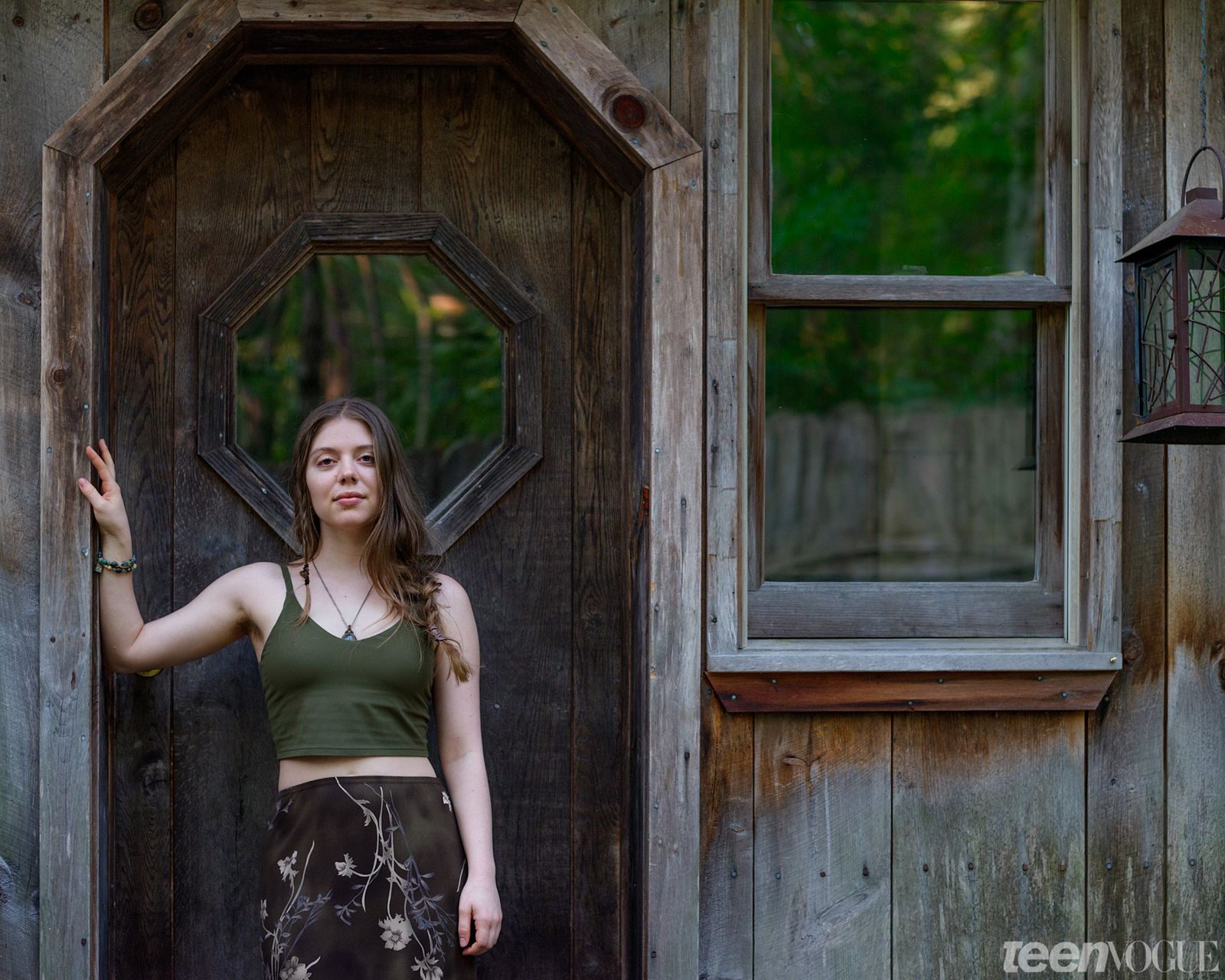 A portrait of Madison Healey outside a cottage photographed in Shutesbury Massachusetts.