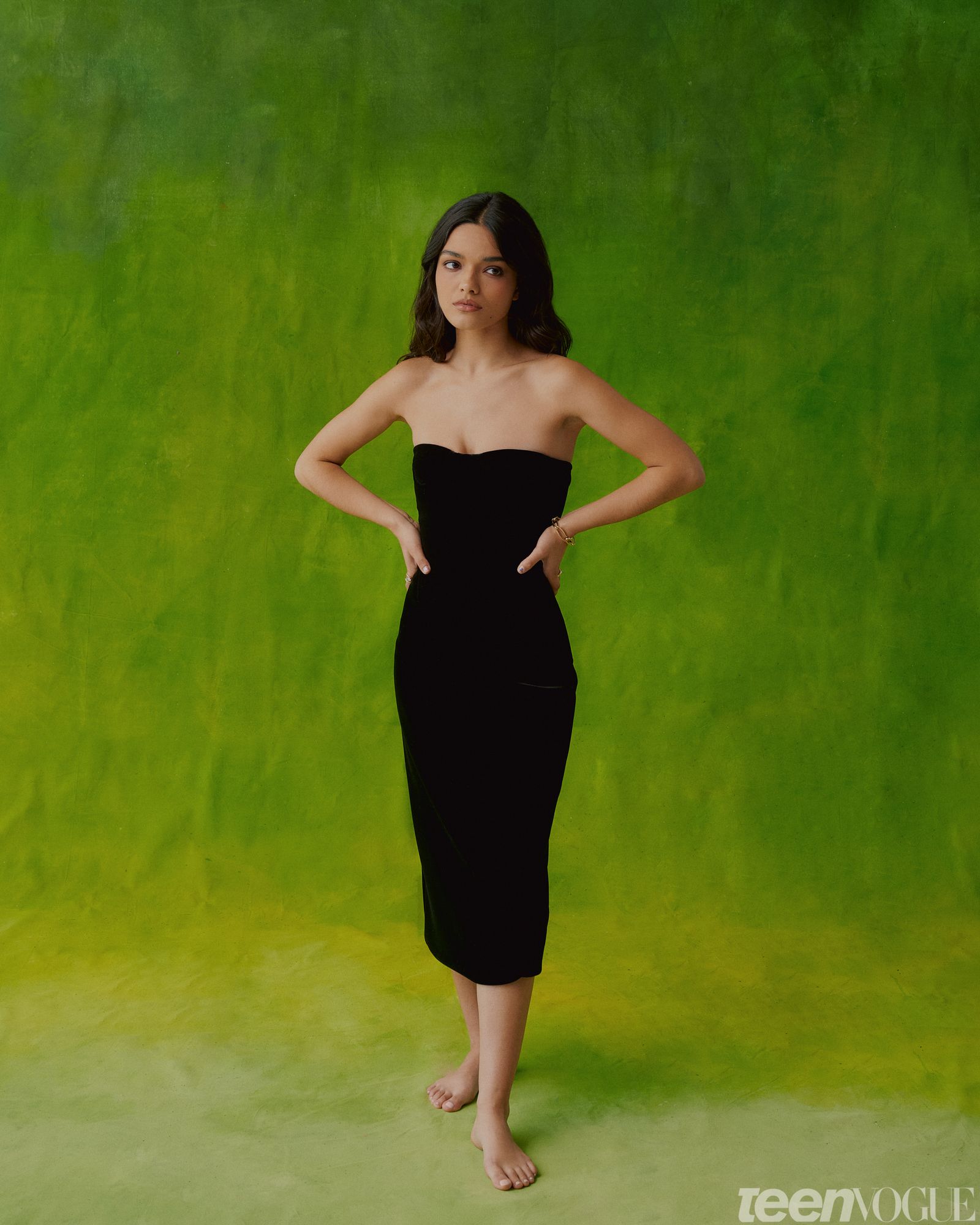 Rachel in a strapless black anklelength gown and hands on her hips.