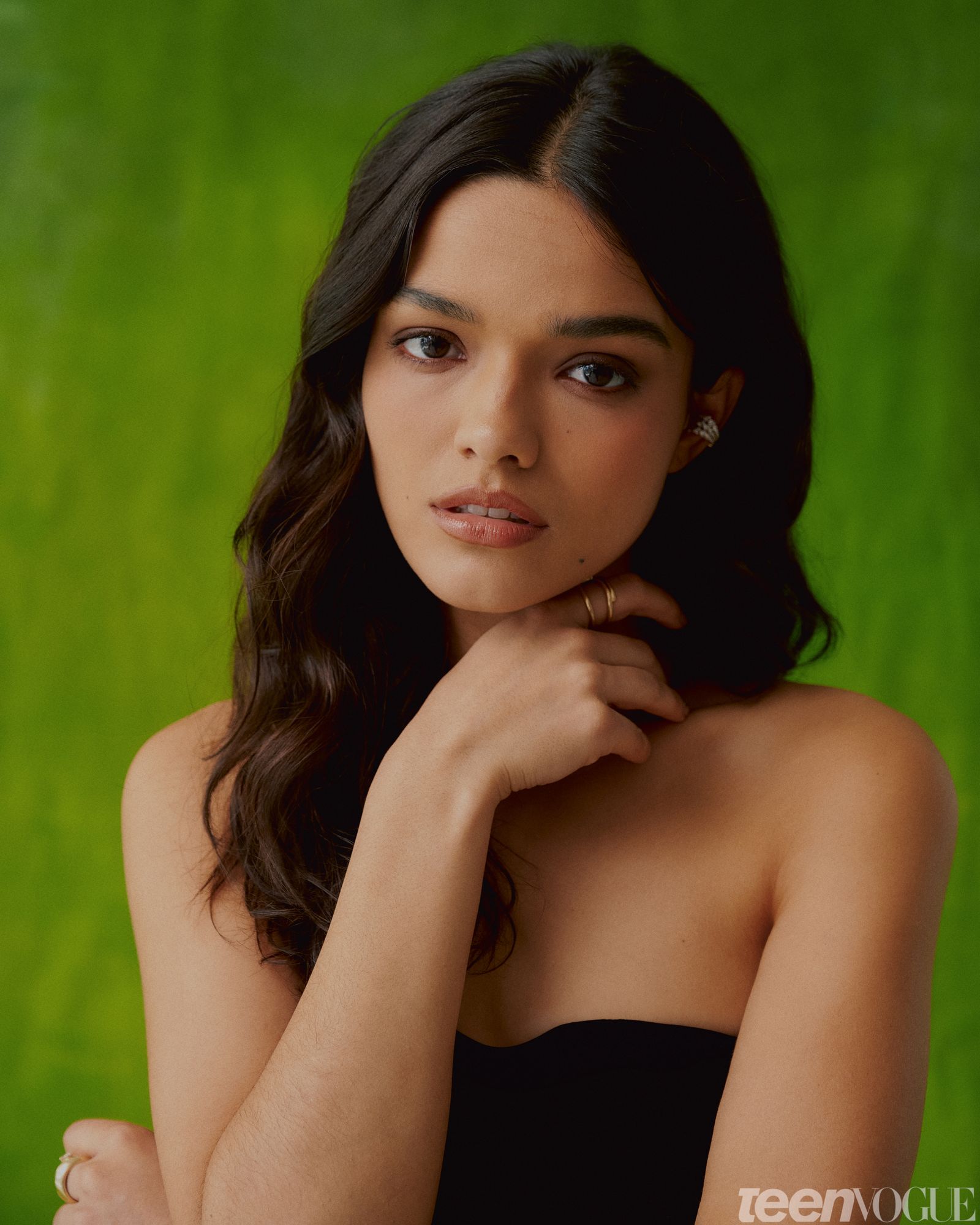 Rachel wearing strapless black gown with one hand resting under her face.